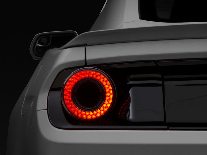 Raxiom 15-22 Ford Mustang Halo LED Tail Lights - Gloss Black Housing (Smoked Lens) - Bull Strap