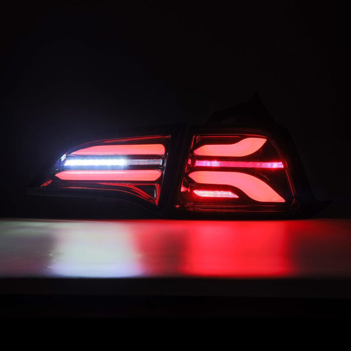 AlphaRex 17-22 Tesla Model 3 PRO-Series LED Tail Lights Jet Black w/Seq Sig - Bull Strap