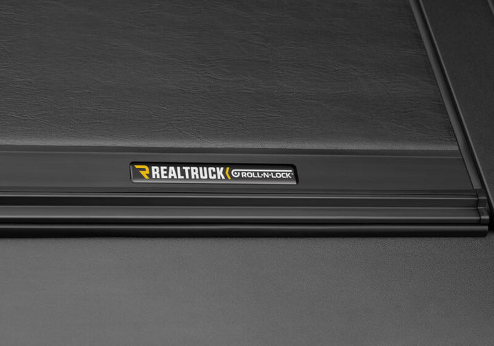 Roll-N-Lock 19-23 RAM 1500 w/o Swing Gate Tailgate SB 76.3in M-Series Retractable Tonneau Cover - Bull Strap