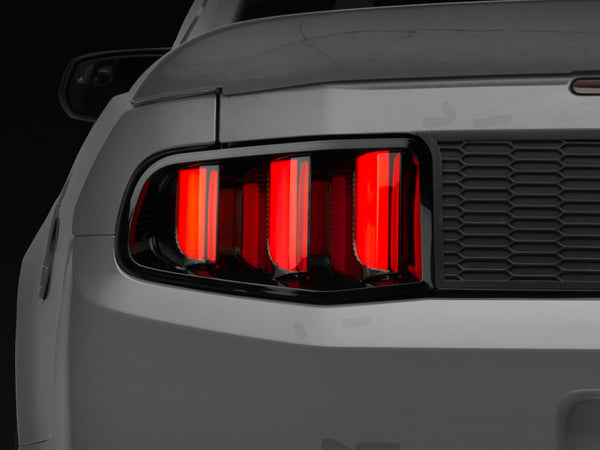 Raxiom 10-12 Ford Mustang Vector V2 LED Tail Lights - Gloss Black Housing (Clear Lens) - Bull Strap