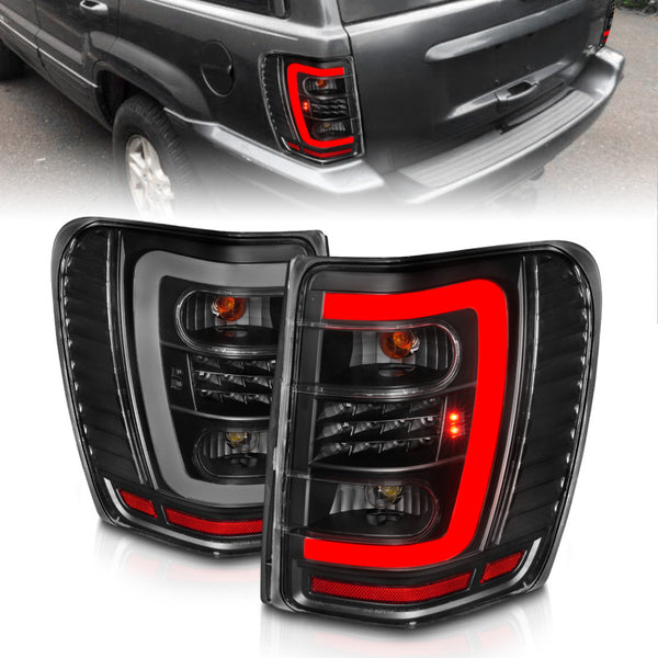 ANZO 1999-2004 Jeep Grand Cherokee LED Tail Lights w/ Light Bar Black Housing Clear Lens - Bull Strap