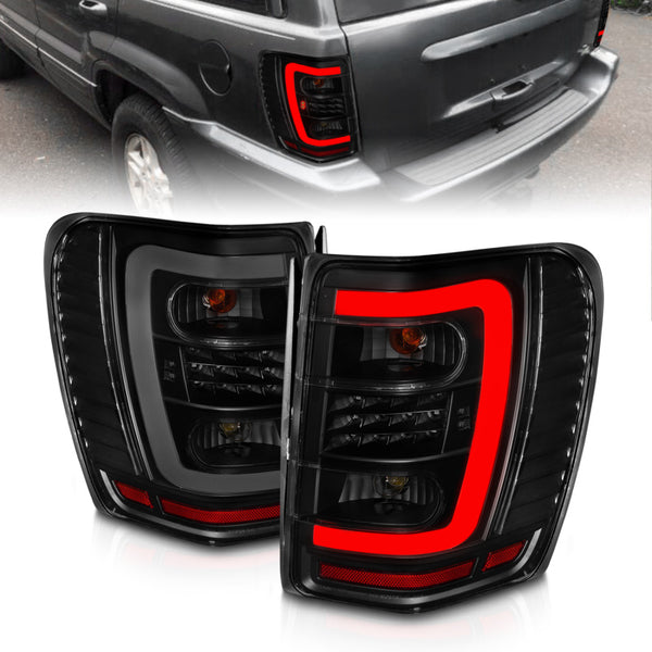 ANZO 1999-2004 Jeep Grand Cherokee LED Tail Lights w/ Light Bar Black Housing Smoke Lens - Bull Strap