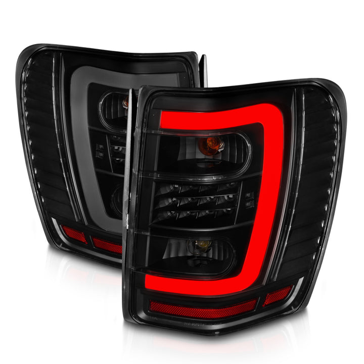 ANZO 1999-2004 Jeep Grand Cherokee LED Tail Lights w/ Light Bar Black Housing Smoke Lens - Bull Strap
