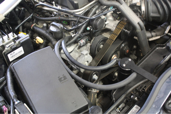 J&L 12-15 Chevrolet Camaro ZL1 6.2L Passenger Side Oil Separator 3.0 - Black Anodized - Bull Strap