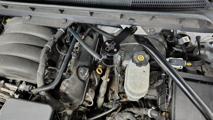 J&L 14-18 Chevy Silverado 1500 / 14-18 GMC Sierra 1500 4.3L V6 Oil Separator - Black Anodized - Bull Strap