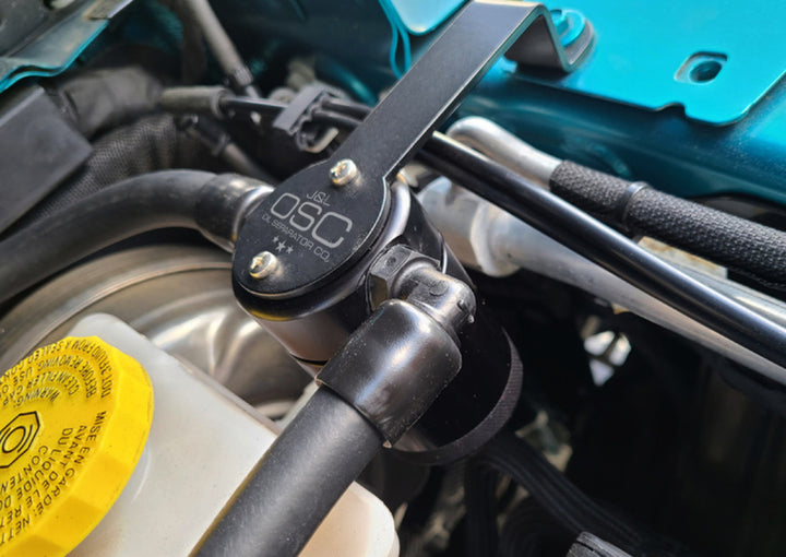 J&amp;L 20-25 Jeep Wrangler 2.0L Driver Side Oil Separator 3.0 - Black Anodized - Bull Strap