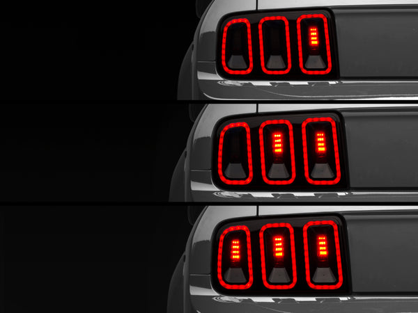 Raxiom 05-09 Ford Mustang Gen5 Tail Lights- Black Housing (Smoked Lens) - Bull Strap