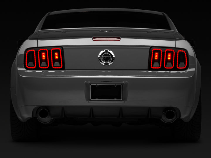 Raxiom 05-09 Ford Mustang Gen5 Tail Lights- Black Housing (Smoked Lens) - Bull Strap