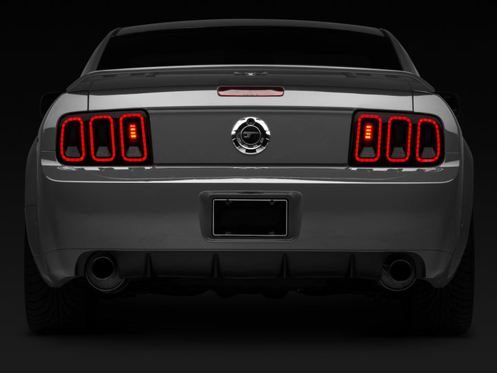 Raxiom 05-09 Ford Mustang Gen5 Tail Lights- Black Housing (Smoked Lens) - Bull Strap