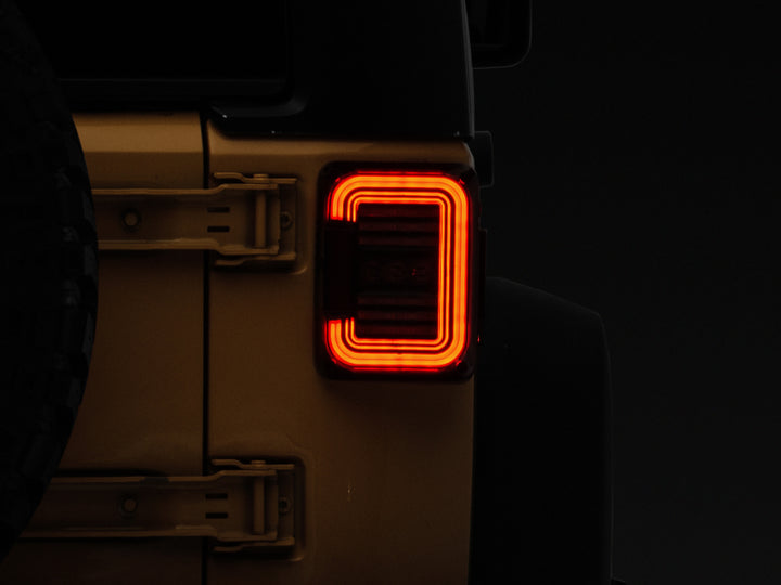 Raxiom 07-18 Jeep Wrangler JK Axial Series LED Halo Tail Lights- Black Housing (Dark Smoked Lens) - Bull Strap