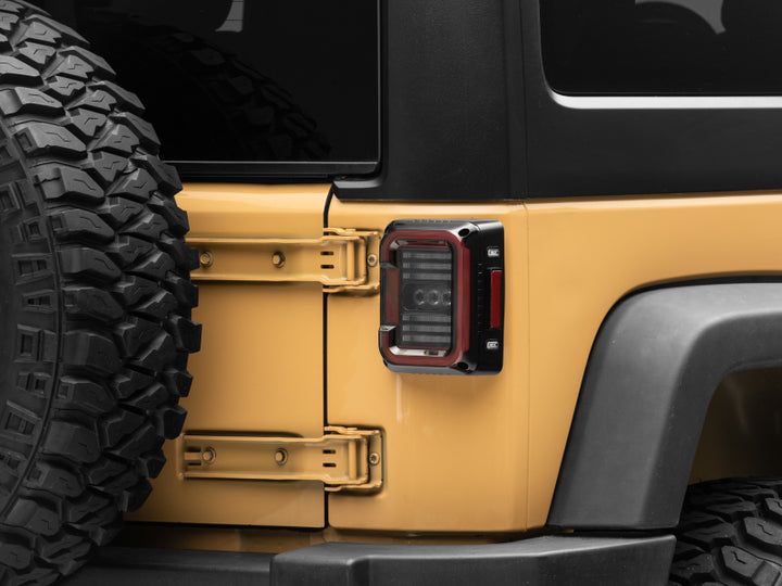 Raxiom 07-18 Jeep Wrangler JK Axial Series LED Halo Tail Lights- Black Housing (Dark Smoked Lens) - Bull Strap