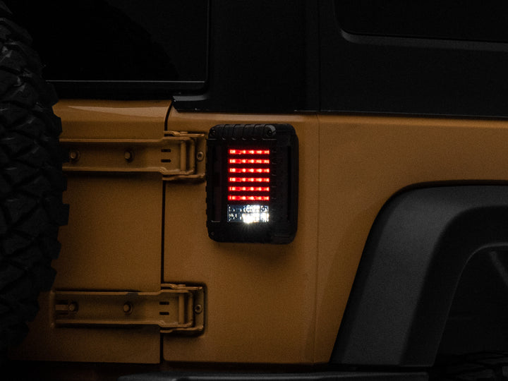 Raxiom 07-18 Jeep Wrangler JK LED Tail Lights- Black Housing (Smoked Lens) - Bull Strap