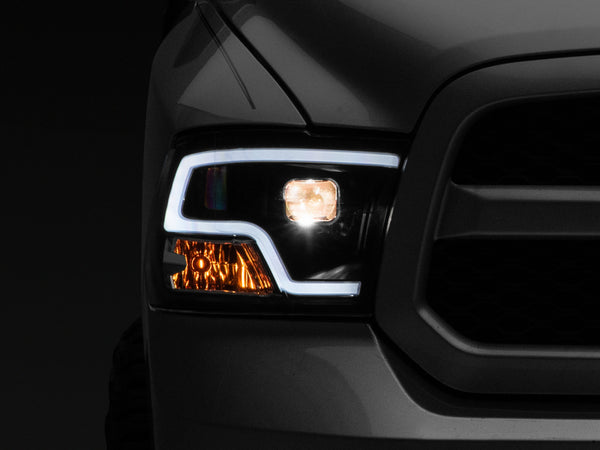 Raxiom 09-18 RAM 1500 LED Halo Projector Headlights- Black Housing (Clear Lens) - Bull Strap
