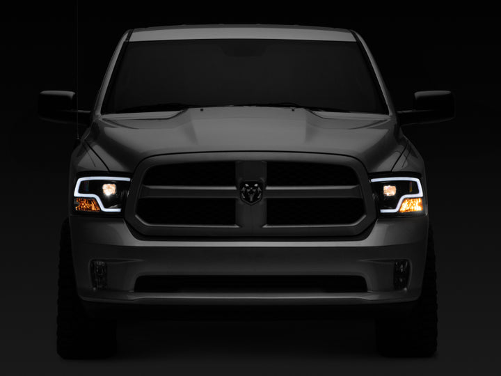 Raxiom 09-18 RAM 1500 LED Halo Projector Headlights- Black Housing (Clear Lens) - Bull Strap