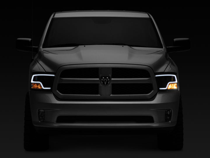 Raxiom 09-18 RAM 1500 LED Halo Projector Headlights- Black Housing (Clear Lens) - Bull Strap