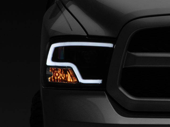 Raxiom 09-18 RAM 1500 LED Halo Projector Headlights- Black Housing (Clear Lens) - Bull Strap