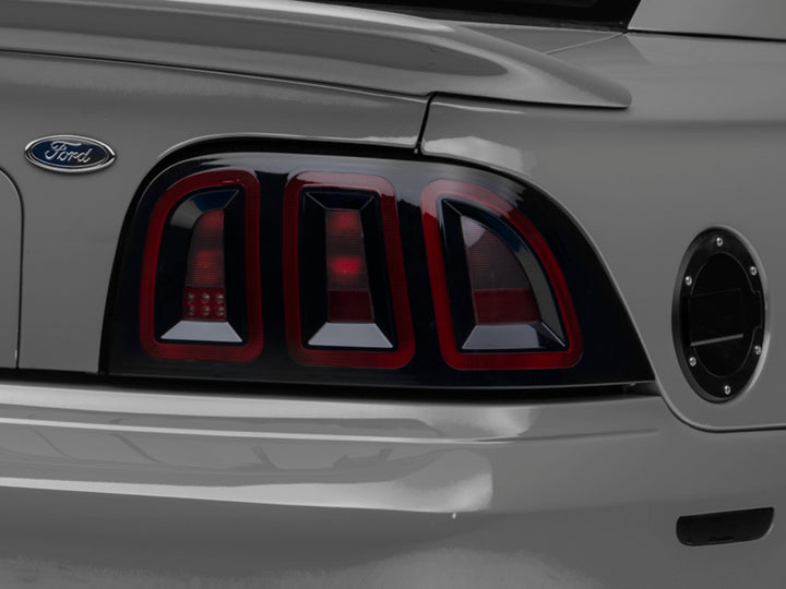 Raxiom 96-98 Ford Mustang Icon LED Tail Lights- Black Housing (Smoked Lens) - Bull Strap
