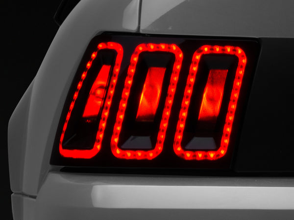 Raxiom 99-04 Ford Mustang Excluding 99-01 Cobra Icon LED Tail Lights- Black Housing (Smoked Lens) - Bull Strap