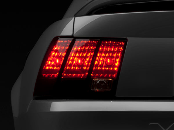 Raxiom 99-04 Ford Mustang Excluding 99-01 Cobra Tail Lights- Black Housing (Smoked Lens) - Bull Strap