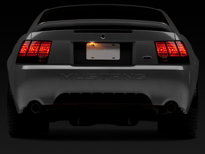 Raxiom 99-04 Ford Mustang Excluding 99-01 Cobra Tail Lights- Black Housing (Smoked Lens) - Bull Strap
