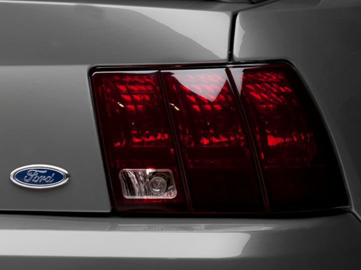 Raxiom 99-04 Ford Mustang Excluding 99-01 Cobra Tail Lights- Black Housing (Smoked Lens) - Bull Strap