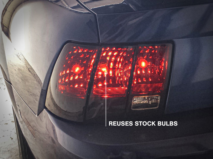 Raxiom 99-04 Ford Mustang Excluding 99-01 Cobra Tail Lights- Black Housing (Smoked Lens) - Bull Strap