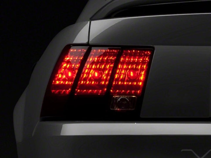 Raxiom 99-04 Ford Mustang Excluding 99-01 Cobra Tail Lights- Black Housing (Smoked Lens) - Bull Strap